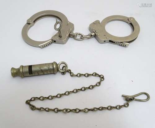 An early 20thC Metropolitan Police whistle by Shand Mason & Co. Together with 20thC Police handcuffs