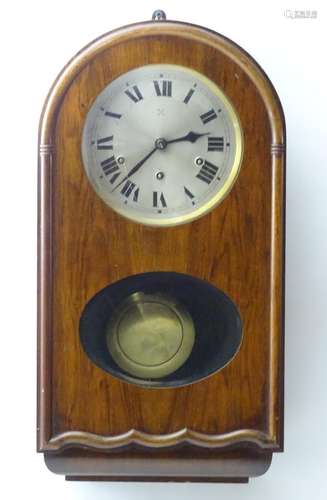 An early to mid 20thC wall clock, the arch top mahogany case with glazed sections, the 7