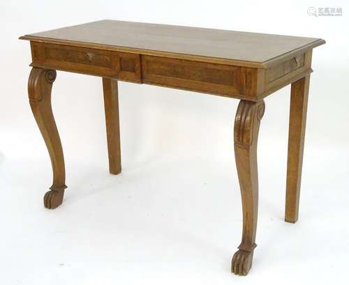 A late 19thC oak serving table with a rectangular moulded top above a moulded frieze and carved