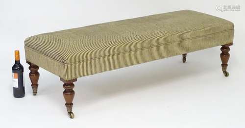 A late 20thC / early 21st stool with a rectangular upholstered top with stud detailing above four