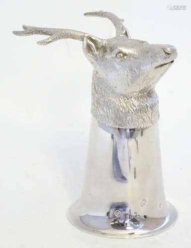 A Silver stirrup cup with stags head decoration. Hallmarked Sheffield 1998. Maker Camelot Silverware