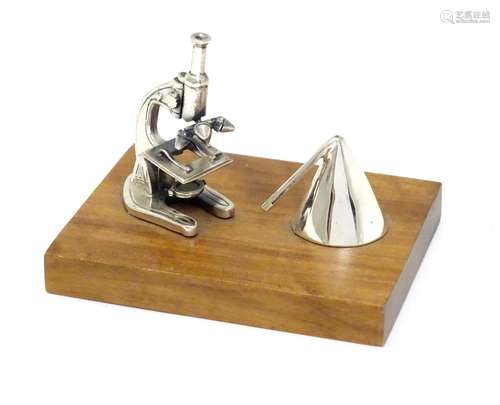 A Continental .925 silver miniature model of a microscope etc. mounted on a wooden base. Approx.