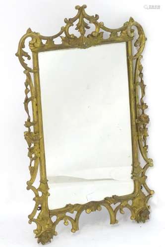 A 19thC Rococo style giltwood mirror with a pierced and carved surround. 23