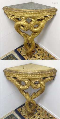 A pair of 19thC marble topped console tables with giltwood and gesso frames depicting carved