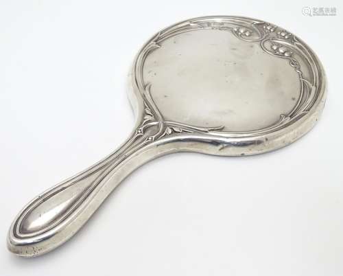 A silver hand mirror with Art Nouveau decoration. hallmarked Birmingham 1912 maker Martin Hall &