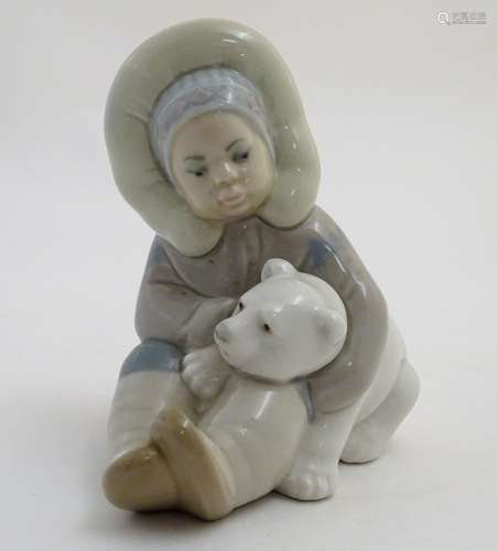 A Lladro figure of an Eskimo girl with a polar bear, model no. 1195. Marked under. Approx. 4 3/4