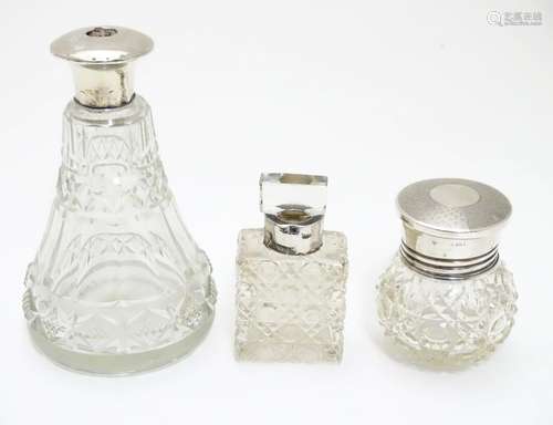 3 assorted glass toilet bottles with silver mounts and lids. The tallest approx 5