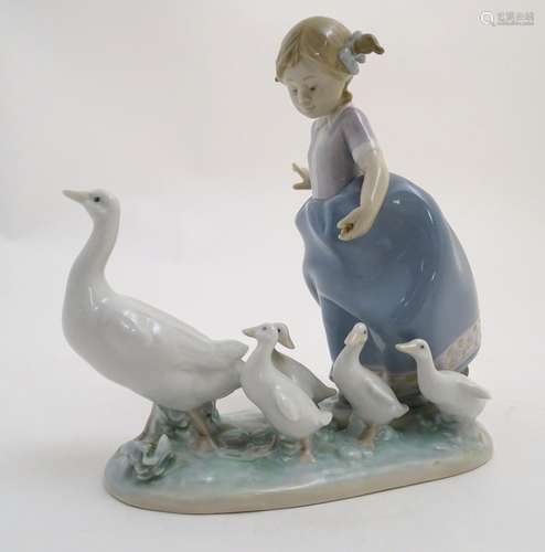 A Lladro figure of a girl with ducks, Hurry Now, model no. 5503. Marked under. Approx. 7