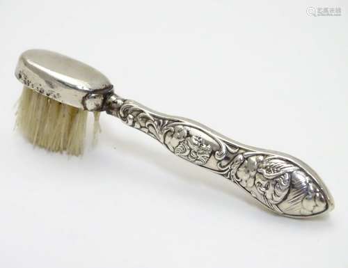 A silver handled moustache brush with embossed detail. Hallmarked Birmingham 1903 maker Adie Lovekin