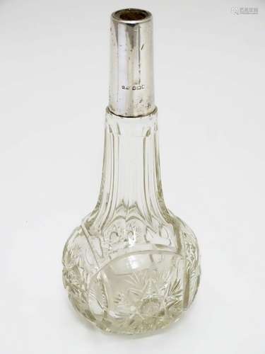 An early 20thC cut glass scent bottle with silver collar. 6 1/4