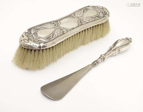 An Art Nouveau silver mounted clothes brush with peacock decoration, hallmarked Birmingham 1901