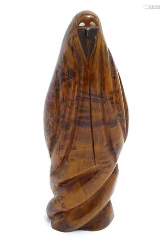 A 20thC carved wooden sculpture depicting a Middle Eastern veiled woman with inlaid mother of