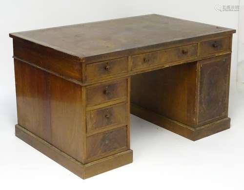 A late 19thC Georgian style partners desk with an inset leather top above two banks of drawers and