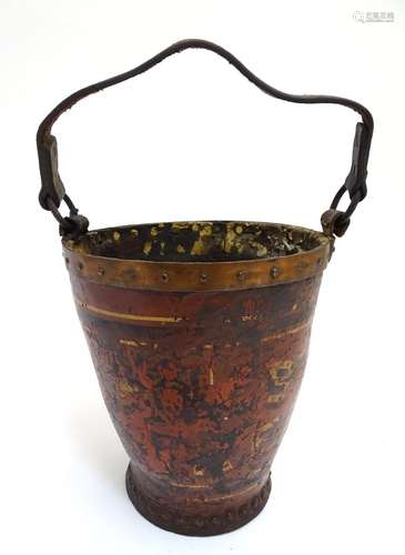 A 19thC leather fire bucket of tapered cylindrical form with a leather strap handle, stud