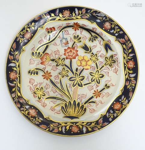 A Copeland plate decorated with flower and foliage with a bird in a cage with cobalt blue and gilt