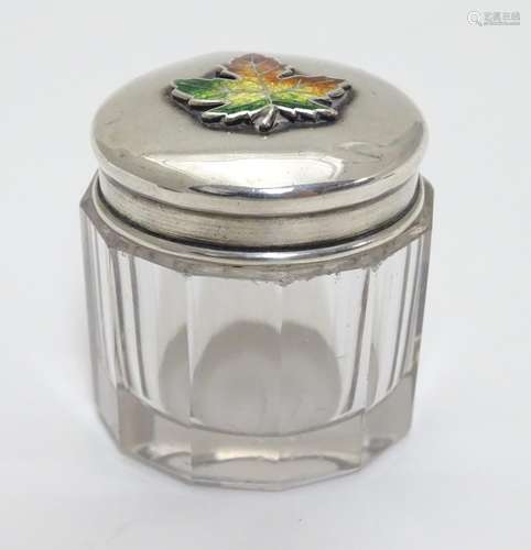 A glass toilet pot with Sterling silver lid having maple leaf decoration with enamel detail. Maker