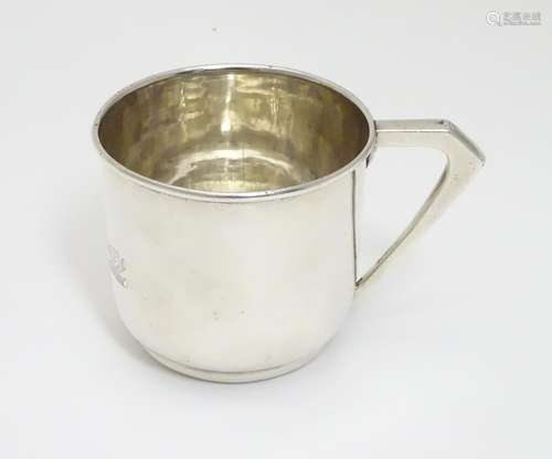 A Silver christening cup, the front engraved with three graduated teddy bears. Hallmarked Birmingham