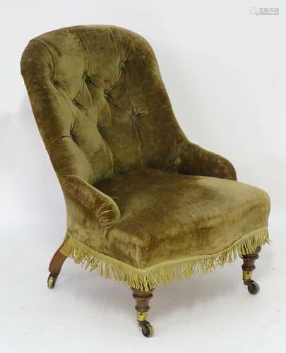 A late 19thC chair with button back upholstery and sprung seat above four mahogany legs