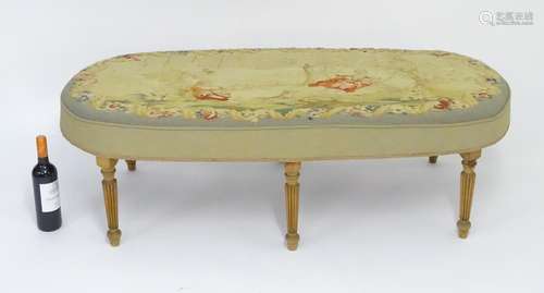 A late 20thC / early 21stC stool with a needlework top above six tapering reeded legs. 52