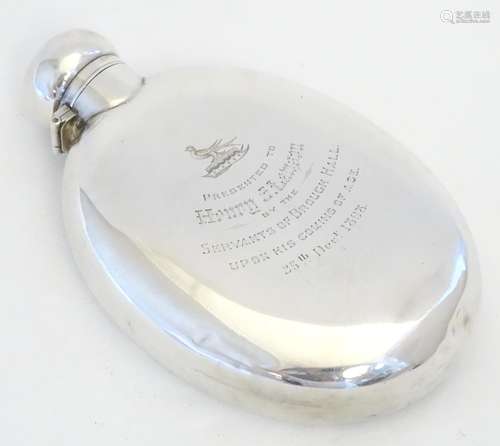 A large Victorian silver hip flask of ovoid form. Engraved ' presented to Henry J Lamson by the