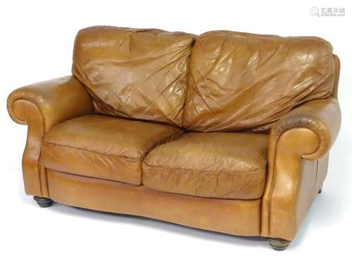 A late 20thC Italian tan leather two-seat sofa, 67