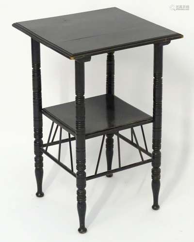 A late 19thC Aesthetic movement E.W Godwin designed ebonised table with a moulded top above four