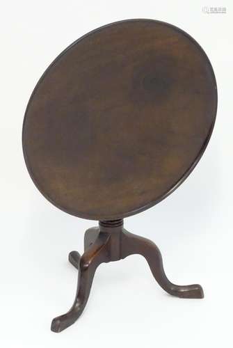 A late 19thC mahogany small proportion tilt top table with a turned pedestal base and three cabriole