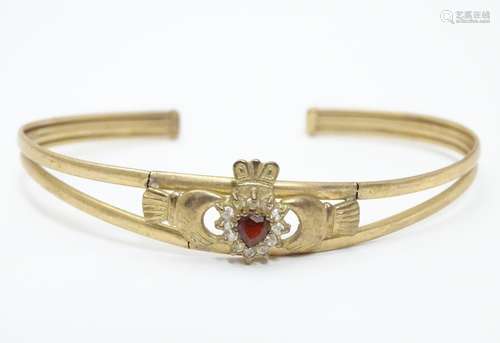 A 9ct bracelet with Claddagh decoration to centre set with red and white stones. Please Note - we do