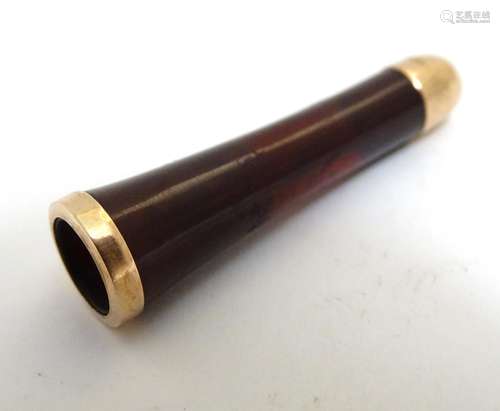 A 19thC red amber cheroot mouthpiece with gilt metal mounts. Approx. 1 3/4