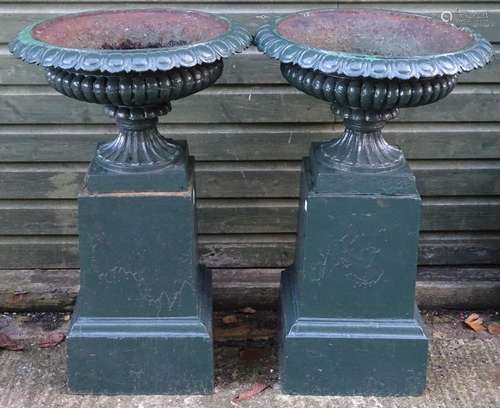 Garden & Architectural, Salvage: a pair of late 19thC cast iron urns with plinth bases, in green