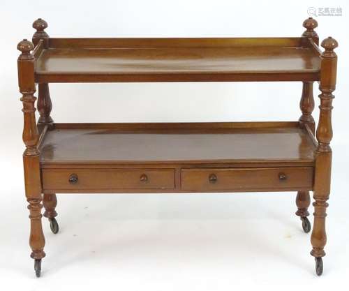 An early 20thC mahogany buffet with two tiers above two short drawers and raised on turned