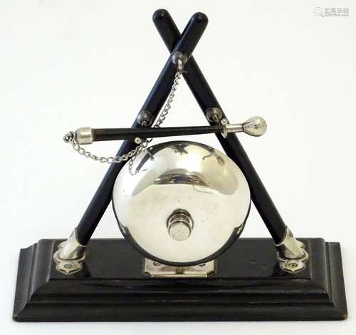 A 20thC counter bell mounted as a table gong on an ebonised base. Approx. 7