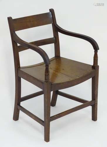 An early 19thC mahogany open armchair with shaped arms and reeded supports above squared tapering