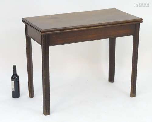 A late 18thC mahogany tea table with a rectangular top above chamfered moulded legs. 36? long x