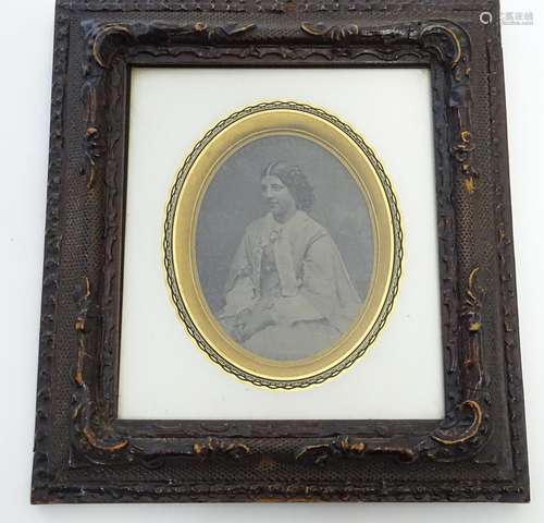 A Victorian daguerreotype photographic portrait of a seated woman, framed. Ascribed verso: An