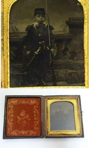 A Victorian daguerreotype /ambrotype depicting a portrait of a young boy in soldier uniform