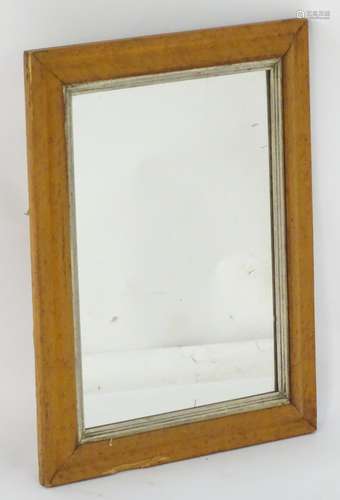 An early 20thC mirror with a birdseye maple frame and a painted surround. Measuring 17