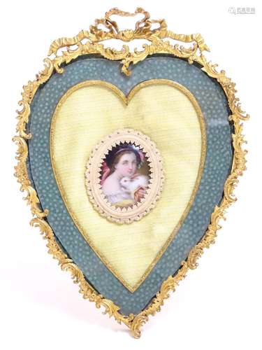 A 19thC gilt brass easel back frame of heart form with ribbon cresting and a shagreen surround, with