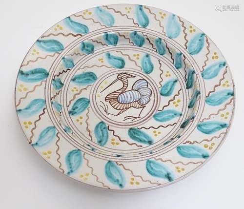 A 20thC Scandinavian hand painted plate / charger, the central medallion decorated with a stylised