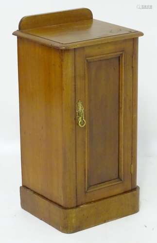 A late 19thC / early 20thC mahogany bedside cabinet / pot cupboard with a shaped upstand above a