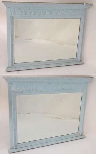 A pair of painted over mantel mirrors with moulded cornices above painted friezes and carved