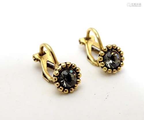 A pair of gilt metal clip earrings set with white stones Please Note - we do not make reference to