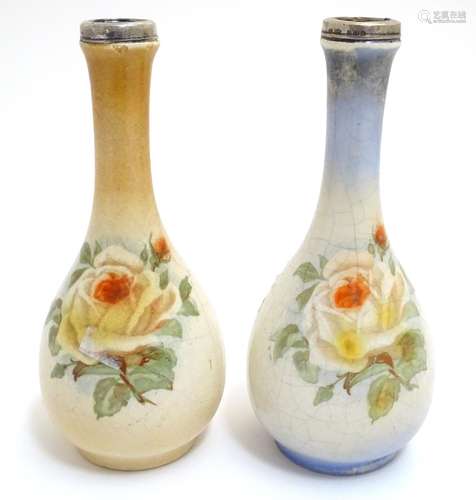 A matched pair of English bottle vases with floral rose decoration with silver rim, hallmarked