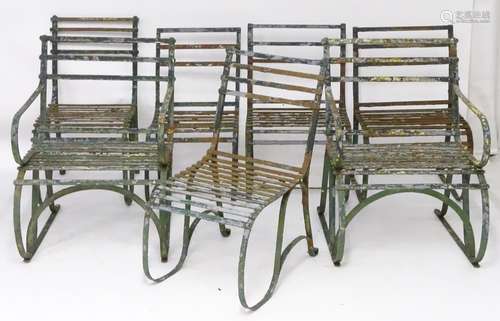 Seven Regency period garden chairs, these wrought iron strap back rails over a seat supported by 'S'