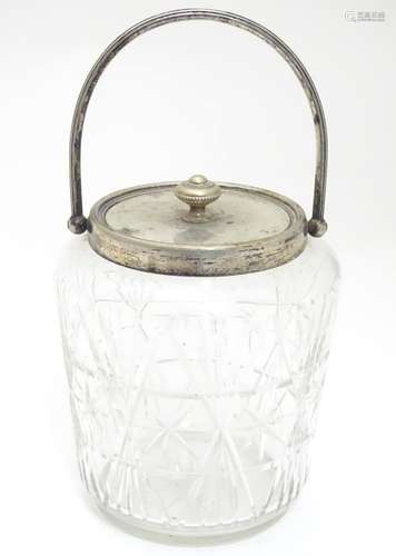 A cut glass biscuit barrel with silver plated mounts . Approx. 7