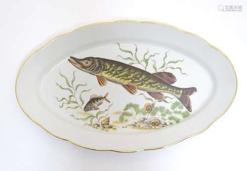 A French oval serving dish with a lobed rim, decorated with an underwater scene depicting a pike