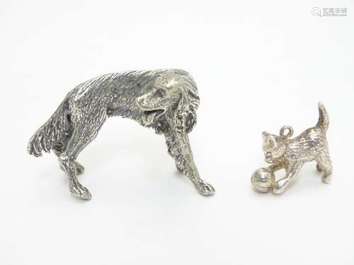 A white metal pendant formed as a kitten playing with a ball of wool together with a cast model of a