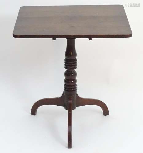 A late 18thC oak tripod table with a rectangular top above a tapering turned pedestal and three