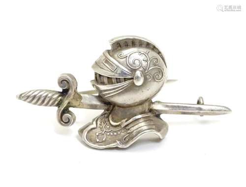 A Victorian silver brooch formed as a sword and knights helmet. Hallmarked Birmingham 1885 maker