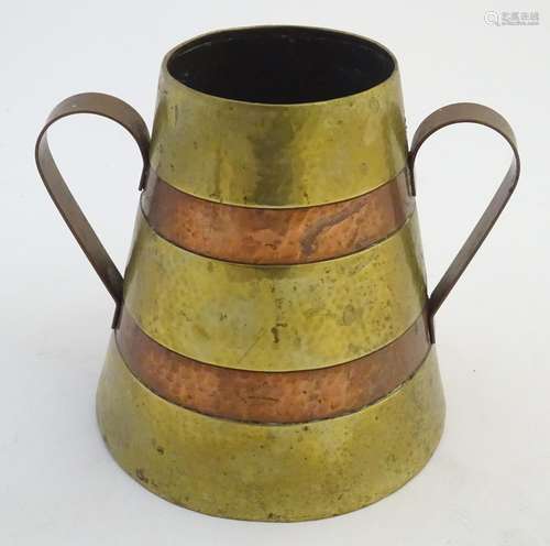 An early 20thC French twin handled brass souvenir vase with copper banding, engraved to one side